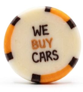 Handcrafted custom corporate rock candy featuring the We Buy Cars logo in orange and black lettering.